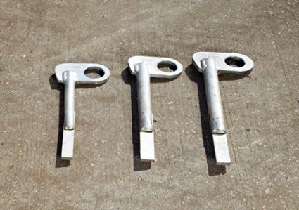 Three silver metal quick release manhole lifting devices