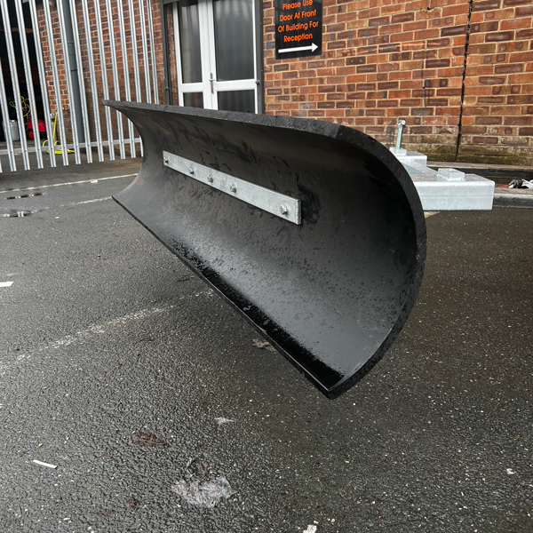Black, curved snow plow blade mounted on a metal frame.