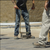 Person using a Paving Block Extractor tool to lift a paving block on a construction site.