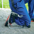 Person kneeling on a metal knee pad seat